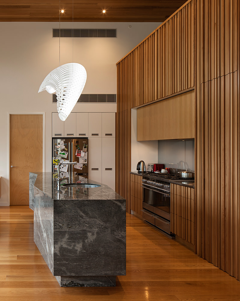 timber architectural interior with marbel kitchen bench