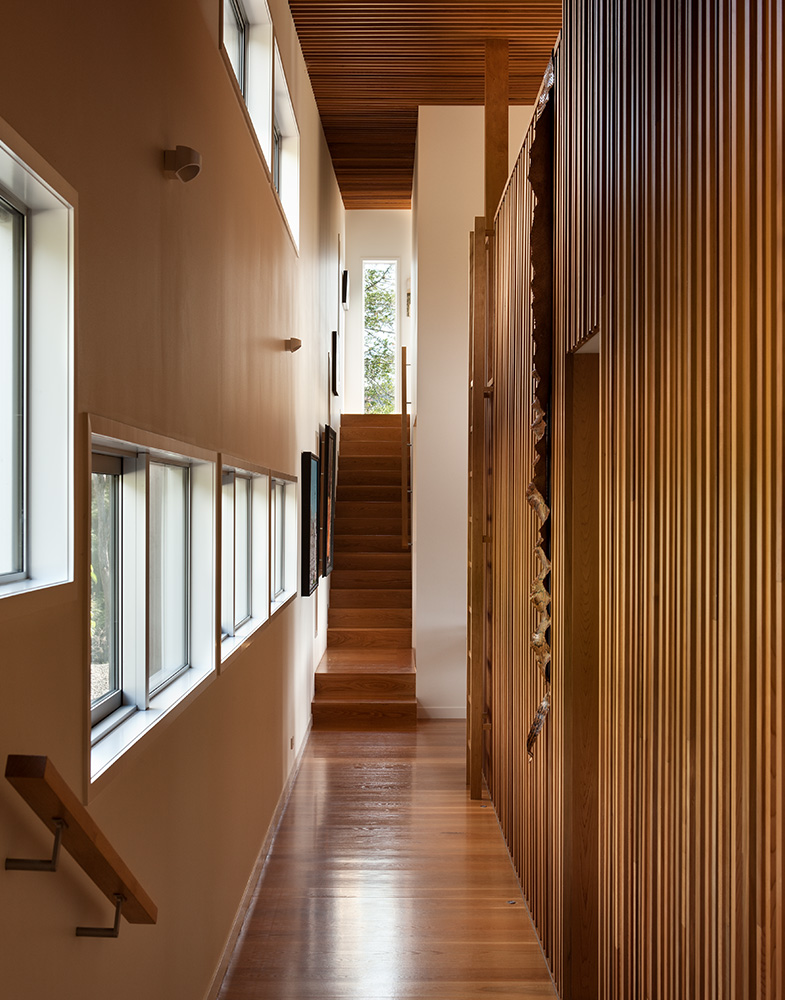 long timber hallway with stairs