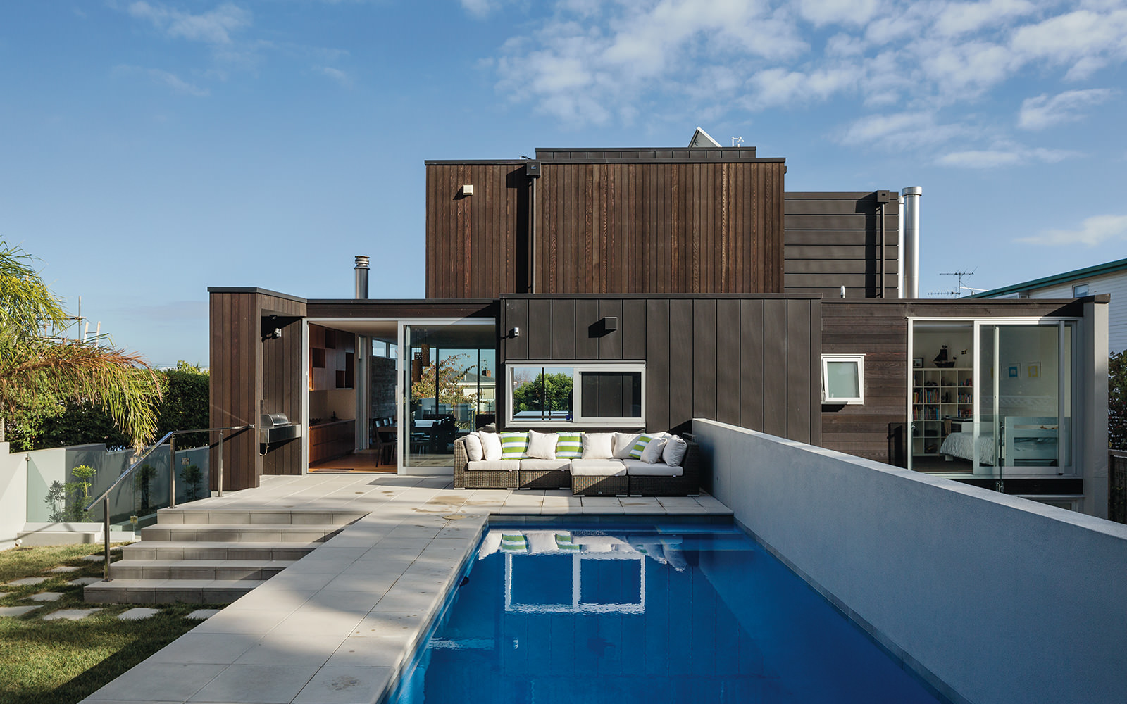 modern timber clad house pool in backyard