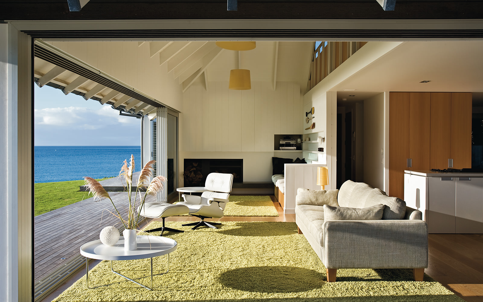 light filled interior green rug by the sea