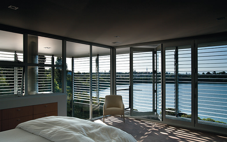 architectural bedroom by water with louvres