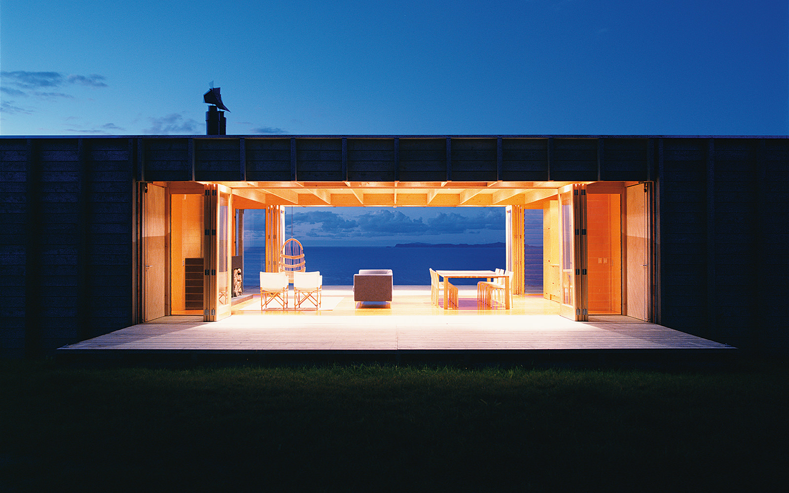 architectural folding beach house NZ at night