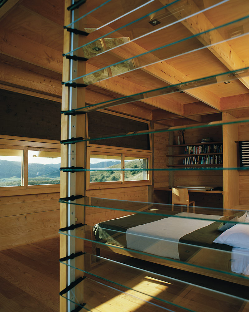 Glass louvres looking into the timber interior of Coromandel Bach bedroom